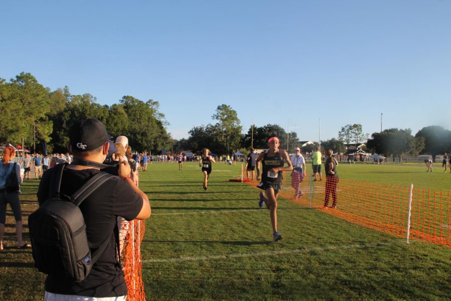 Trystan Capille (‘23) sprints to the finish line with Brady Pavlica (‘24) close on his tail. Capille crosses the line, and within two seconds Pavlica reaches the finish line as well. 