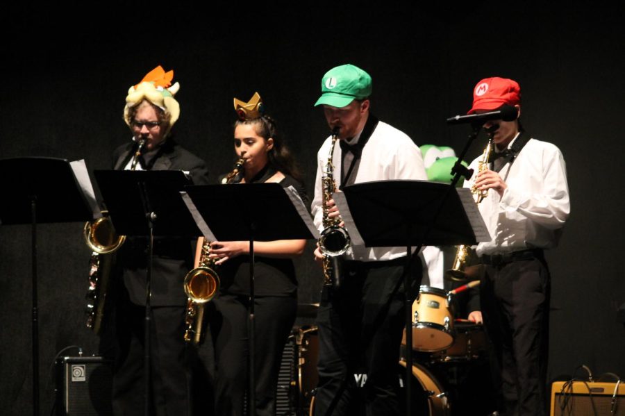 Caption: Titus Johnson plays on the far left in a Mario Brothers themed skit during the bands Prism concert in December. 