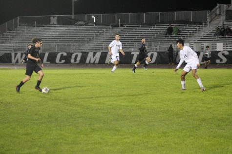 Jameson Mattson (24) charges at his opponent, dribbling the ball downfield.
