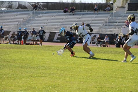 On Mar. 23, Charlie Fisher (23) rushes against a Wesley Chapel player to try to get the ground ball.