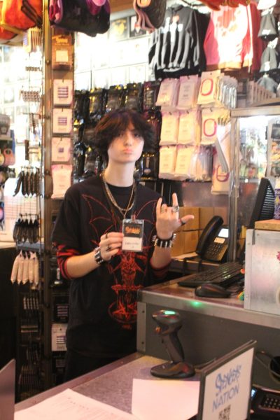 Alexander Tatum (24) poses for the camera at his new job. He works at Spencers behind the counter, learning the tasks that come with working at the store.