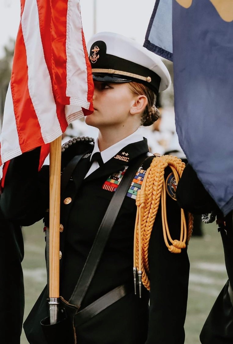 Cadet Commanding officer Emma Bronson (‘24) presents the flag at a football game to display the colors.
Photo by Mrs. Backus