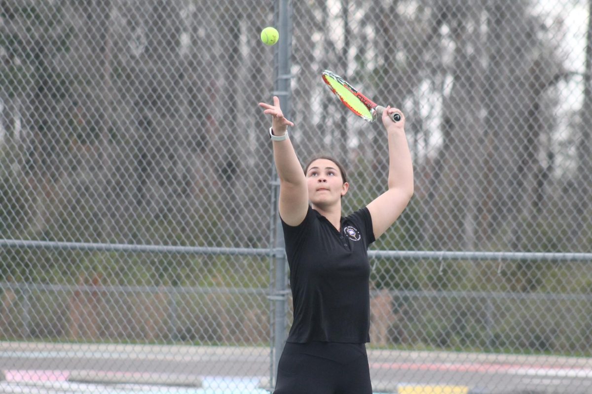 Lauren Tifer (25) serving the ball during tennis practice. I think the team can improve by learning how to work with each other and learning our strengths and weaknesses, Tifer said.