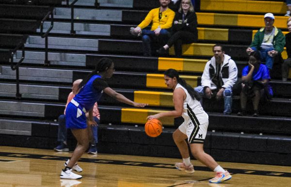  Player 12, Kaylana Little (’27)  runs up the court while number 24, Tahlia Vazquez (’27) has the ball waiting for the right moment to pass to another player on the team.
