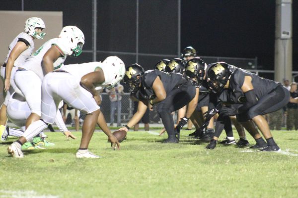 At a home varsity game on Aug. 23, players get ready to hike the ball during the second quarter where the score is 14-12 on the 20 yard line where they ultimately score the touchdown
